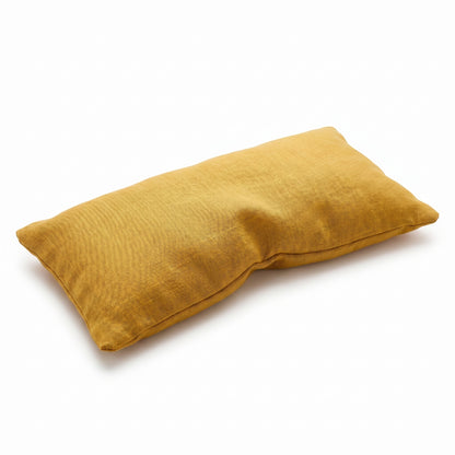 Mustard yellow pillow on a white background