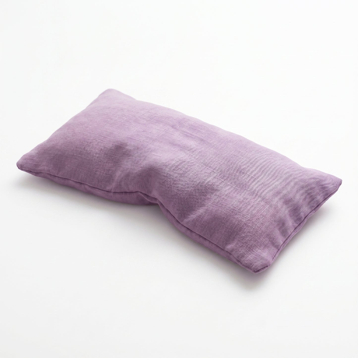 A rectangular lavender pillowcase made of textured, slightly wrinkled linen-like fabric, photographed on a clean white background.