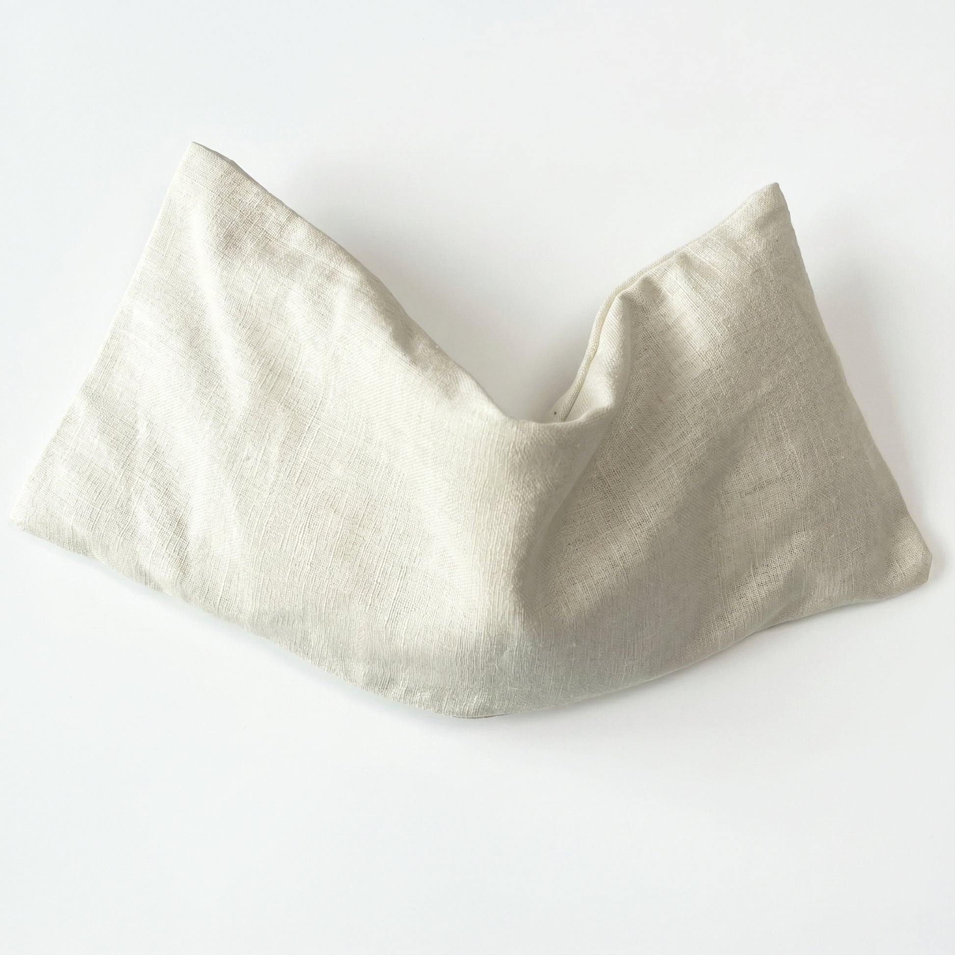 A light beige linen neck warmer or bandana, folded to show its natural woven texture, on a clean white background.